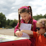 Photo of two girls looking at our wildlife information map.