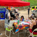 Photo of a group of children colouring at the craft table.