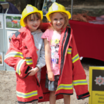 Photo of two young girls dressed up in fire fighter gear!