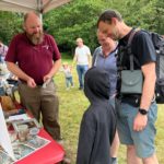 Photo of a family talking to Warden Richard about reptiles.