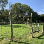 Photo of play equipment for children. Climbing equipment built from wooden posts.