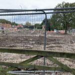 Photo shows fenced-off building work underway in adjacent plot.
