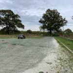 Photo showing a large grvel car park. Plastic mesh makes a good surface and it is level.