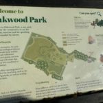 Photo of a greenspace interpretation panel containing a map and wildlife graphics